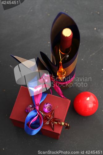 Image of Packaging holiday gifts. Decoration of bottles, packaging bottles of wine