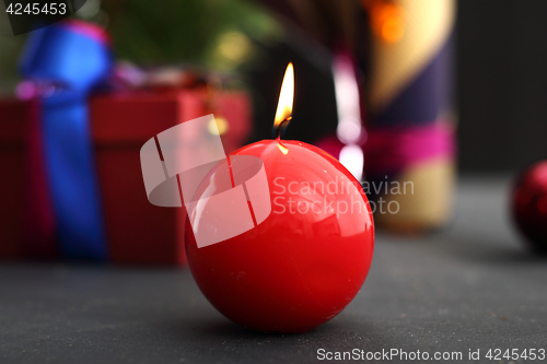 Image of Beautifully wrapped gift Red candle, festive atmosphere in the house