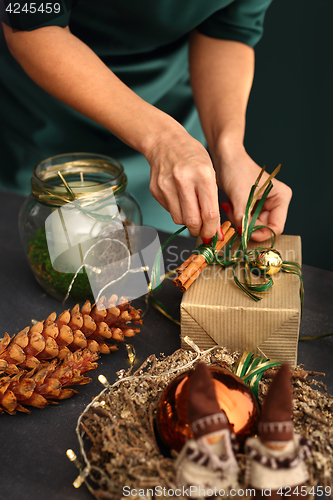 Image of Packaging holiday gifts. Christmas decorations idea of a handmade gift.