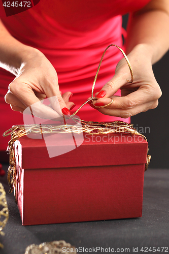 Image of Things you need to pack gifts Woman packs gifts, step by step Woman packs Christmas gift