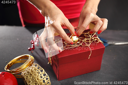 Image of How to wrap a gift for Christmas? Gift wrapping. Christmas gift idea how to decorate a gift