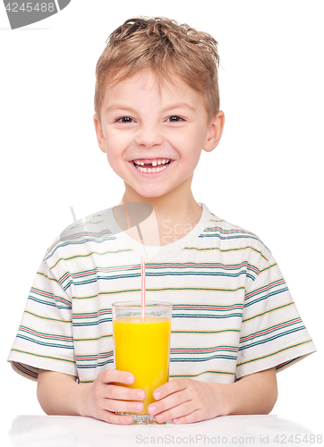 Image of Little boy drinking orange juice