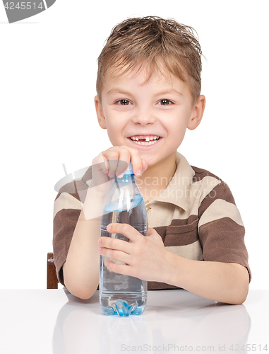Image of Little boy with plastic bottle of water