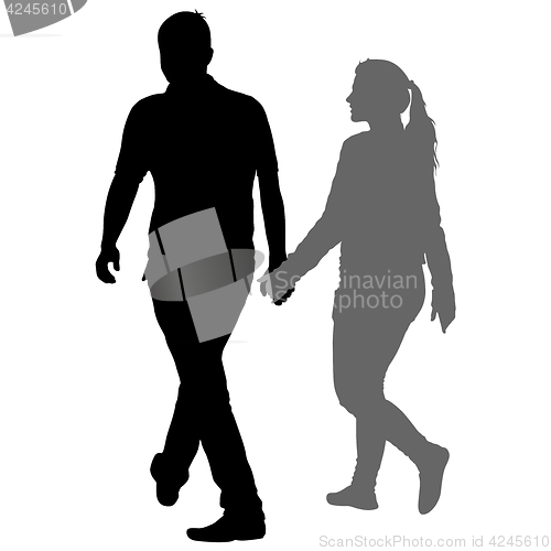 Image of Silhouette man and woman walking hand in hand