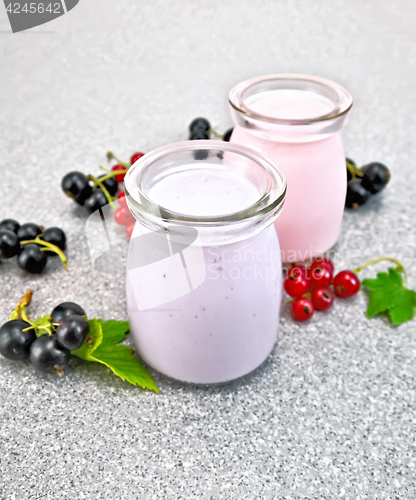 Image of Milk cocktail with black and red currant on stone table