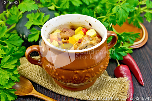 Image of Roast meat and potatoes in pot on board