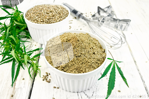 Image of Flour hemp and grain in bowls with leaf on light board