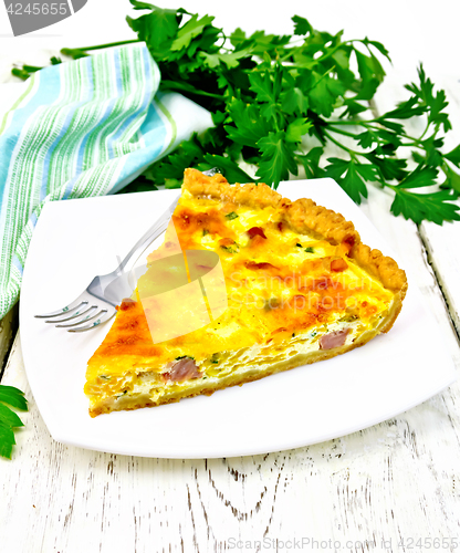 Image of Quiche with pumpkin and bacon in white plate on board