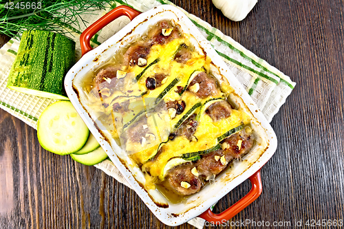 Image of Meatballs with zucchini and nuts in brazier on board top