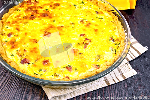 Image of Quiche with pumpkin and bacon in pan on board