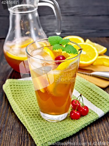 Image of Lemonade with cherries in glassful and jug on board