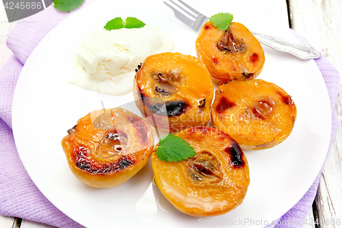 Image of Quince baked with ice-cream in plate on napkin