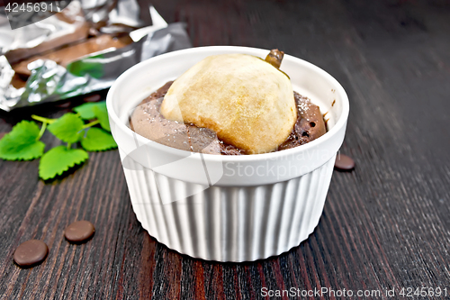 Image of Cake chocolate with pear in white bowl on board