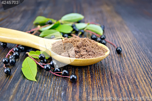 Image of Flour bird cherry in spoon with berries on board