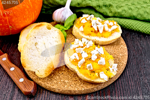 Image of Bruschetta with pumpkin and garlic on board