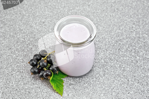Image of Milk cocktail with black currant in jar on stone table