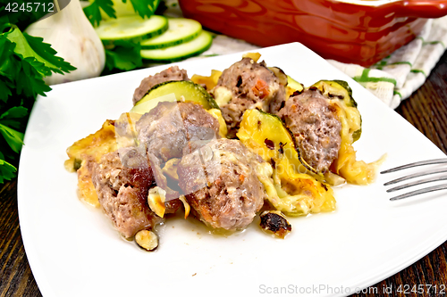 Image of Meatballs with cheese and squash in plate on board