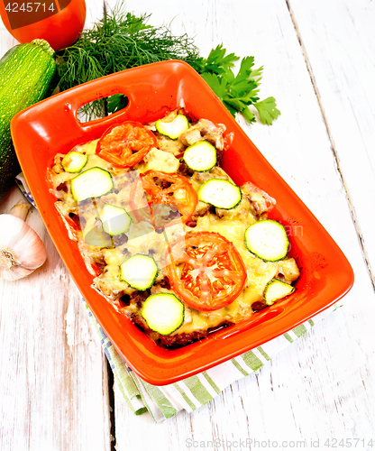 Image of Casserole from minced meat and zucchini in brazier on board