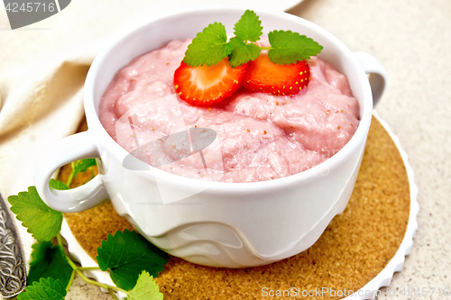 Image of Soup strawberry in bowl with mint on granite table