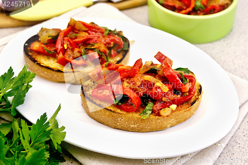 Image of Bruschetta with tomatoes and peppers in plate on table