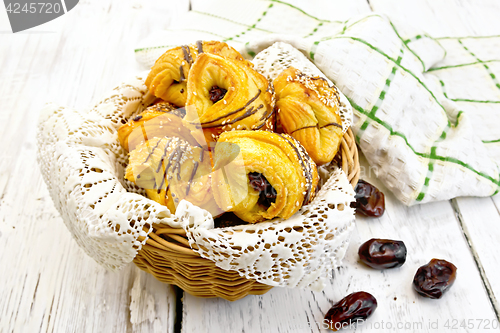Image of Cookies with dates in wicker basket on light board