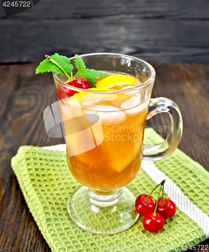 Image of Lemonade cherry and orange in wineglass on dark board