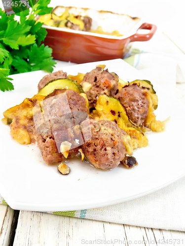 Image of Meatballs with zucchini and nuts in plate on towel