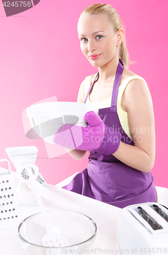 Image of Woman in the kitchen.  Joyful cooking . Kitchen fashion .