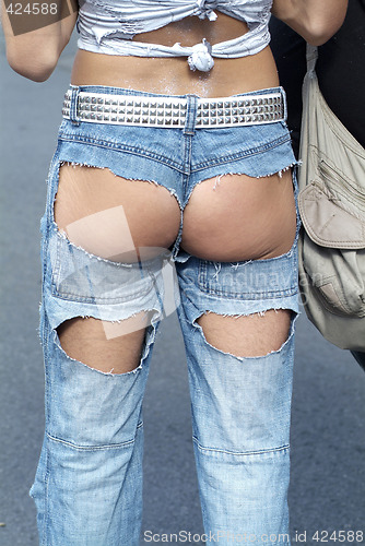 Image of ass in hole of jeans