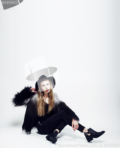 Image of young blonde teenage girl in hat and fur coat, fashion dressed m