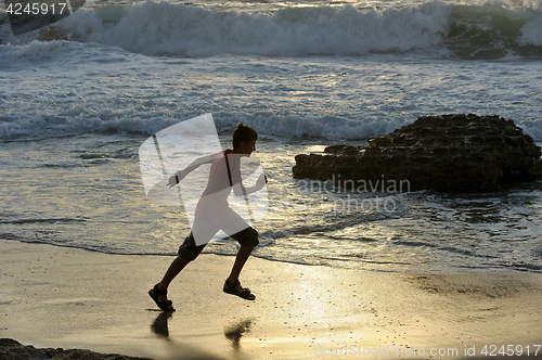 Image of Boy runs along the seashore