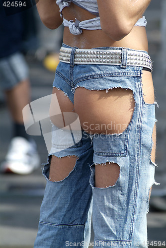 Image of ass in hole of jeans