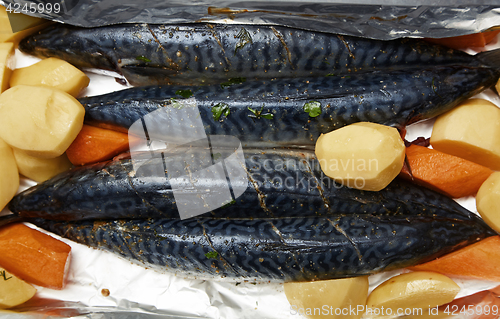 Image of Fish with potato and carrot ready to be cooked