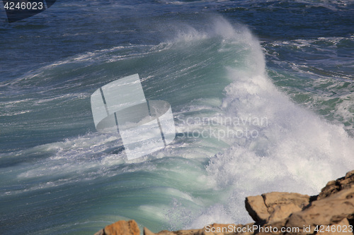 Image of Marine wave breaks against offshore stone