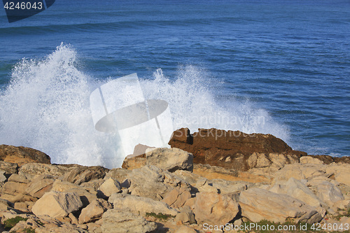 Image of Marine wave breaks against offshore stone