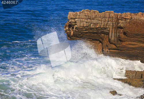 Image of Marine wave breaks against offshore stone