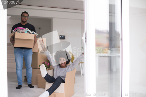 Image of African American couple  playing with packing material