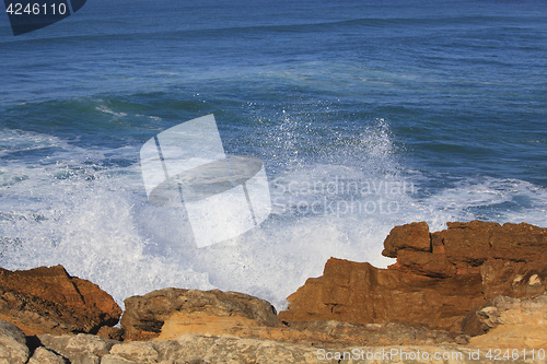Image of Marine wave breaks against offshore stone