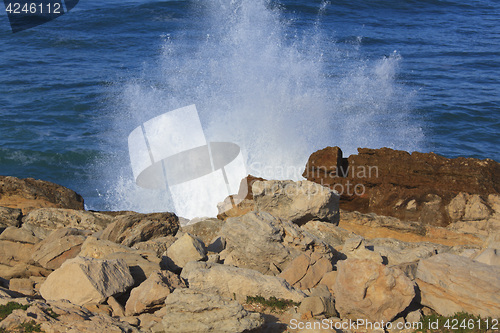 Image of Marine wave breaks against offshore stone