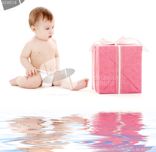 Image of baby boy in diaper with big gift box