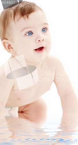 Image of portrait of crawling baby boy looking up