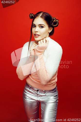 Image of young pretty emitonal posing teenage girl on bright red background, happy smiling lifestyle people concept closeup
