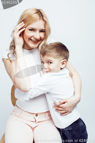 Image of young modern blond curly mother with cute son together happy smiling family posing cheerful on white background, lifestyle people concept, sister and brother friends