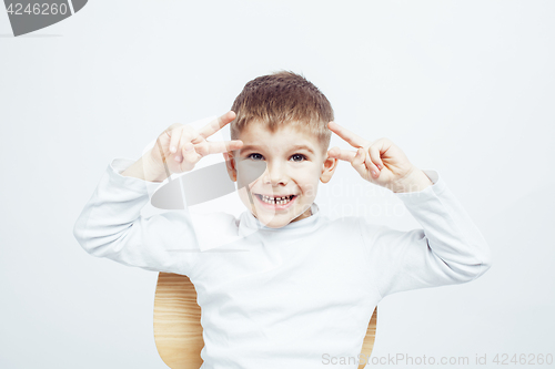 Image of little cute adorable boy posing gesturing cheerful on white background, lifestyle people concept