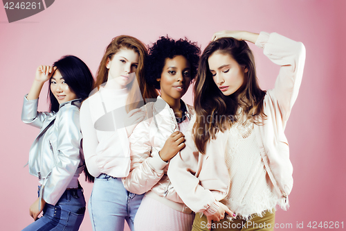 Image of different nation girls with diversuty in skin, hair. Asian, scandinavian, african american cheerful emotional posing on pink background, woman day celebration, lifestyle people concept closeup