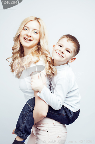 Image of young modern blond curly mother with cute son together happy smiling family posing cheerful on white background, lifestyle people concept, sister and brother friends