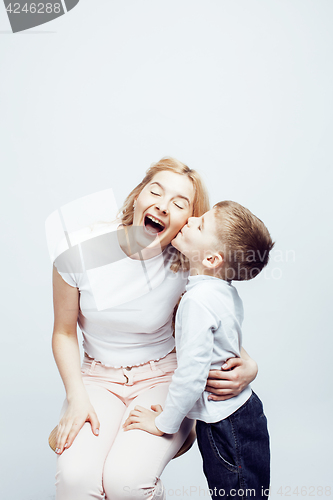 Image of young modern blond curly mother with cute son together happy smiling family posing cheerful on white background, lifestyle people concept, sister and brother friends