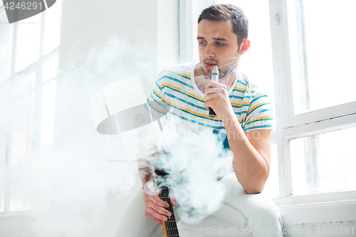 Image of The face of vaping young man