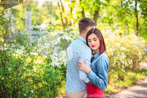 Image of Happy young couple at park standing and laughing on the bright sunny day