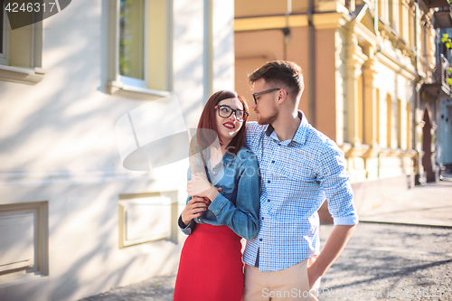 Image of Happy young couple standing at street of city and laughing on the bright sunny day